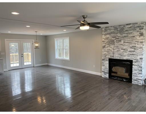 107 County Road Freetown, MA 02717 - Photo 7 of 32 a view of an empty room with wooden floor fireplace and a window