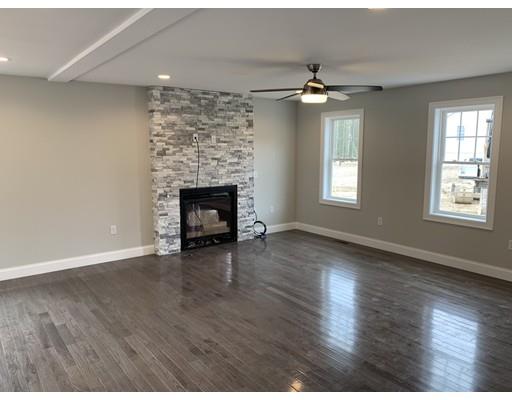 107 County Road Freetown, MA 02717 - Photo 9 of 32 an empty room with wooden floor fireplace and windows