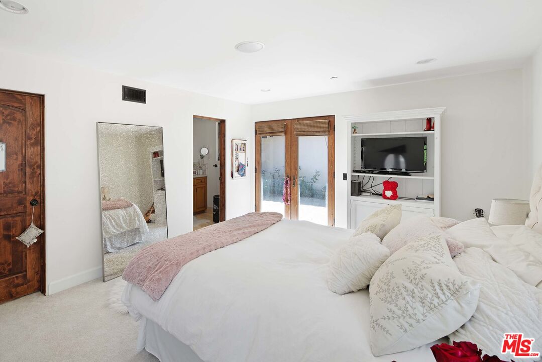 2251 Cold Canyon Road Calabasas, CA 91302 - Photo 26 of 47 a bedroom with a bed and a flat tv screen