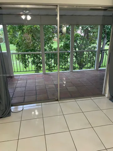 a view of kitchen with stainless steel appliances wooden cabinet and a window