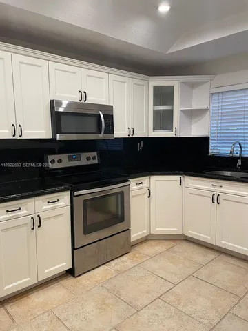 a view of park with swings and trees