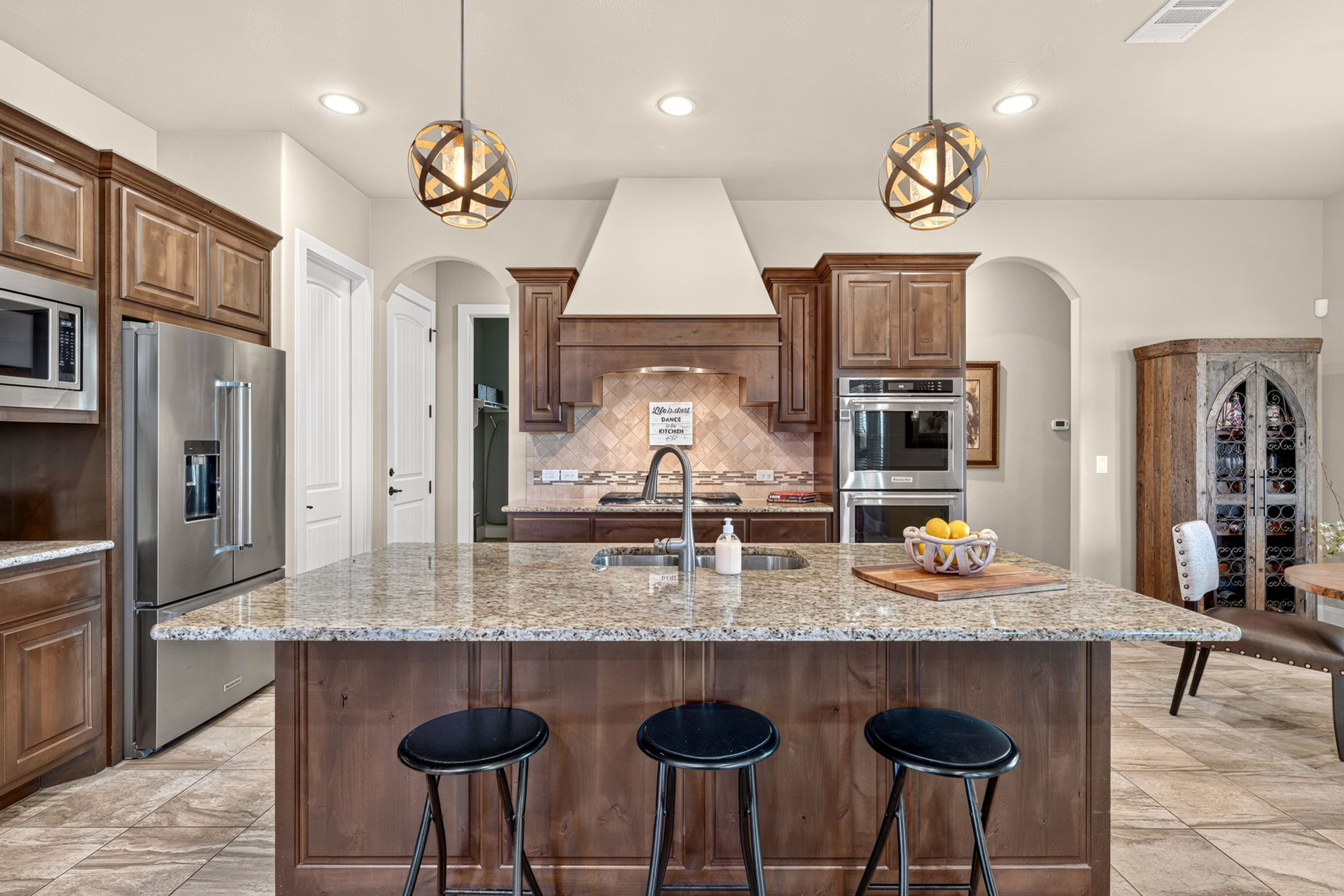 105 Coopers Hill Road Georgetown, TX 78633 - Photo 16 of 40 a kitchen with stainless steel appliances granite countertop a kitchen island a stove and a sink