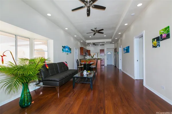 a living room with furniture and a wooden floor