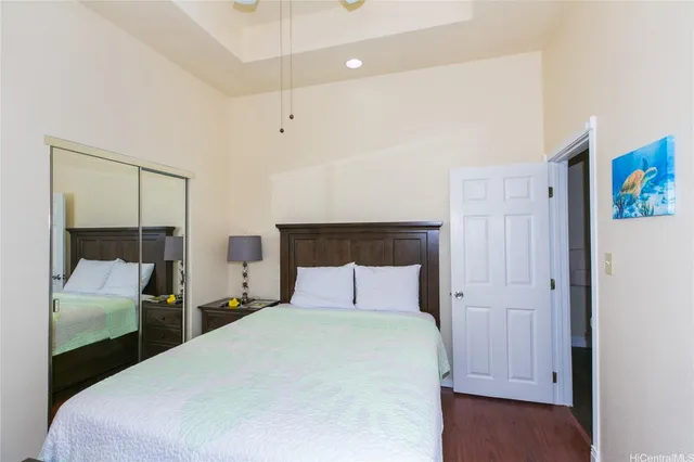 a bedroom with a bed and a large mirror
