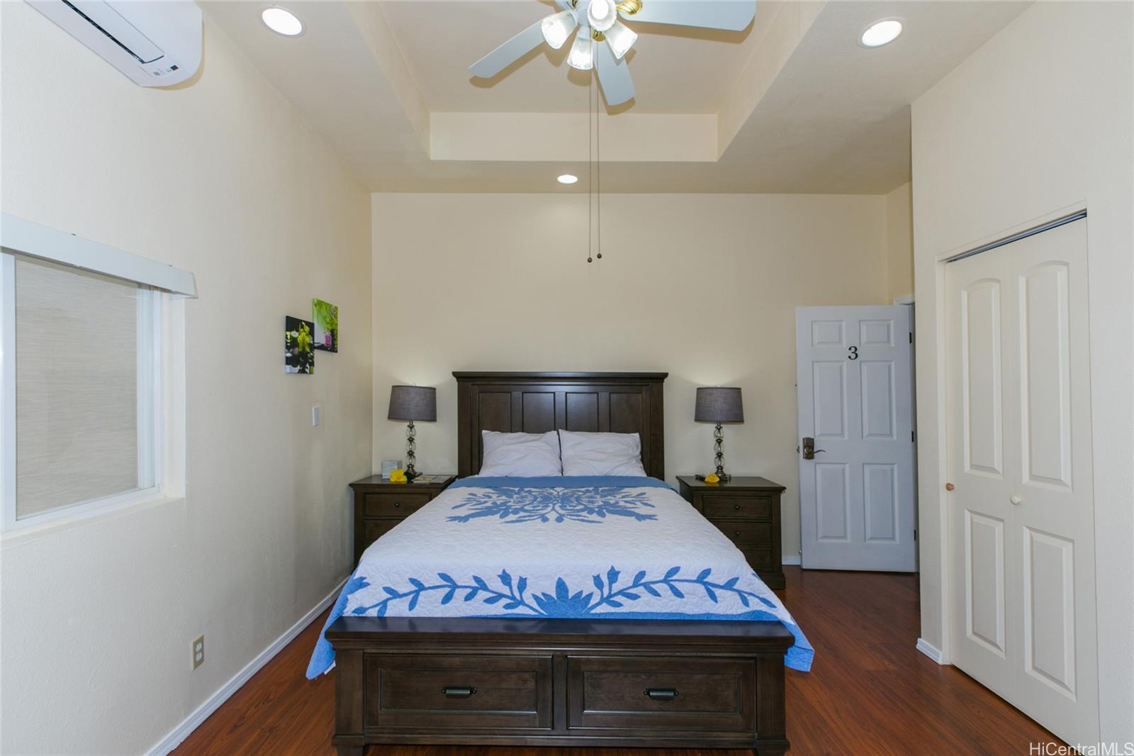 3741 Harding Avenue Honolulu, HI 96816 - Photo 17 of 24 a bedroom with a bed and a chandelier
