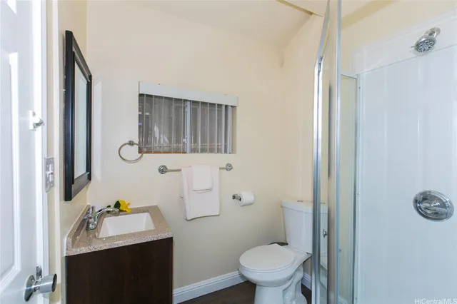 a bathroom with a sink toilet and mirror