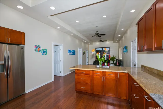a view of a kitchen with stainless steel appliances granite countertop a refrigerator and a sink