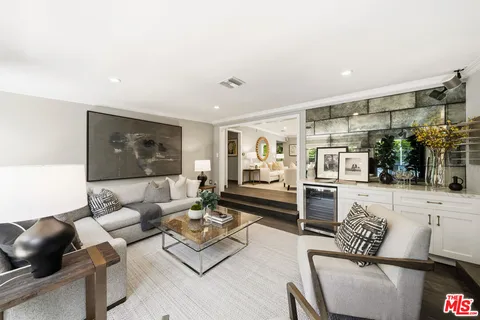 a view of living room with furniture and a painting