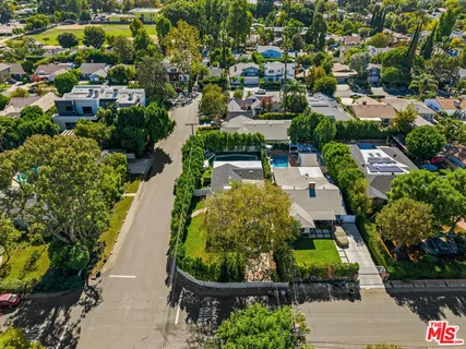 an aerial view of a house with yard swimming pool and outdoor seating