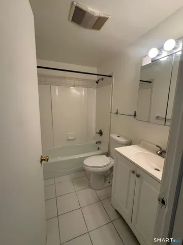 a bathroom with a toilet a sink and shower