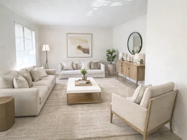 a living room with furniture a mirror and window