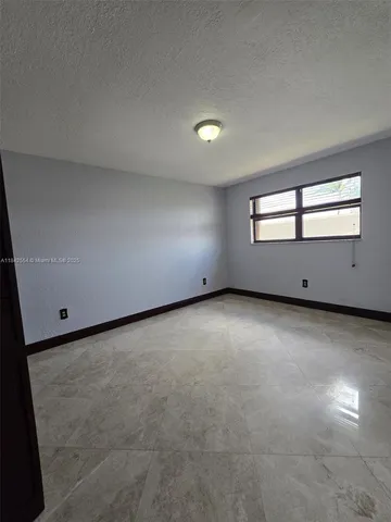 an empty room with a empty space and windows