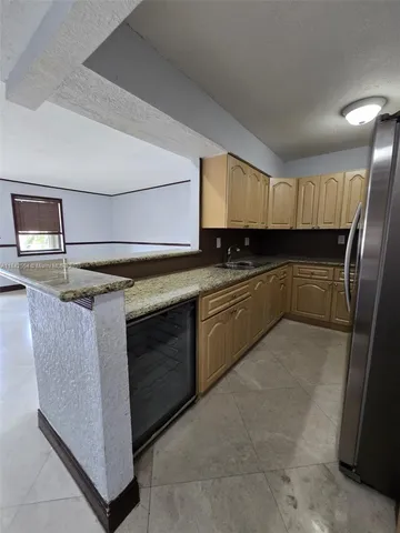 a kitchen with a stove sink and cabinets