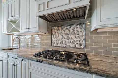 a bathroom with a granite countertop toilet sink and mirror