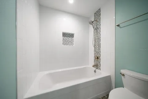 an aerial view of a house with a garden and lake view