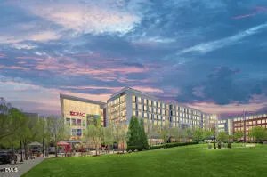 a view of a big building with big yard and large trees