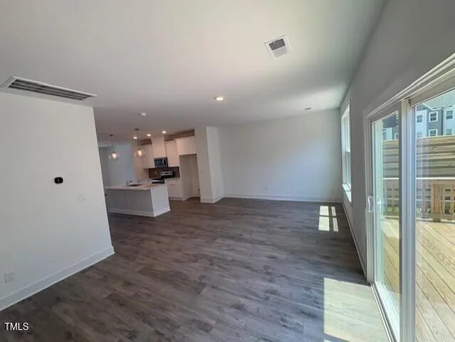 a view of a kitchen with a sink and a refrigerator