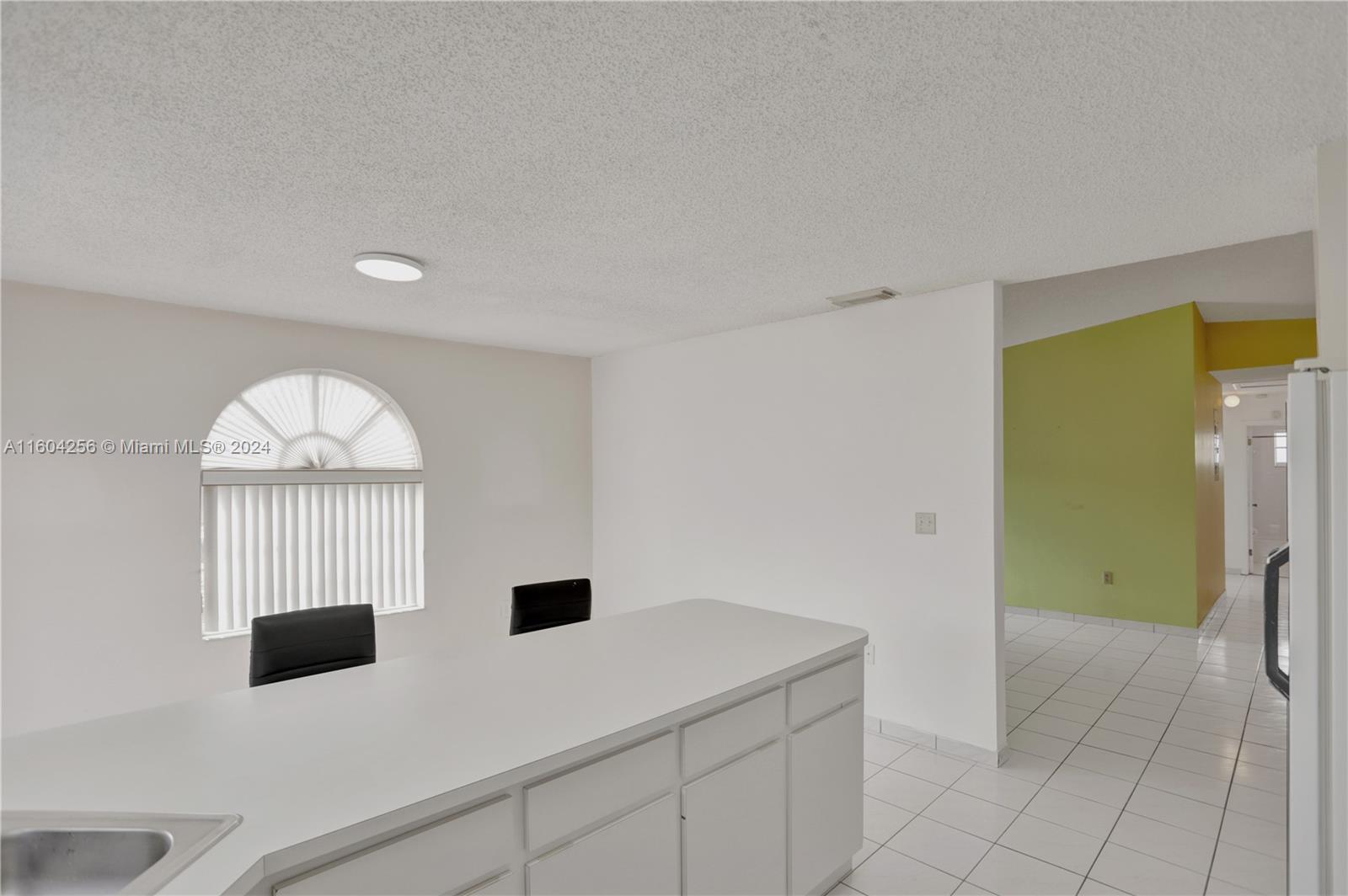 3131 West 79th Place Hialeah, FL 33018 - Photo 14 of 38 a kitchen with a refrigerator and a more cabinets