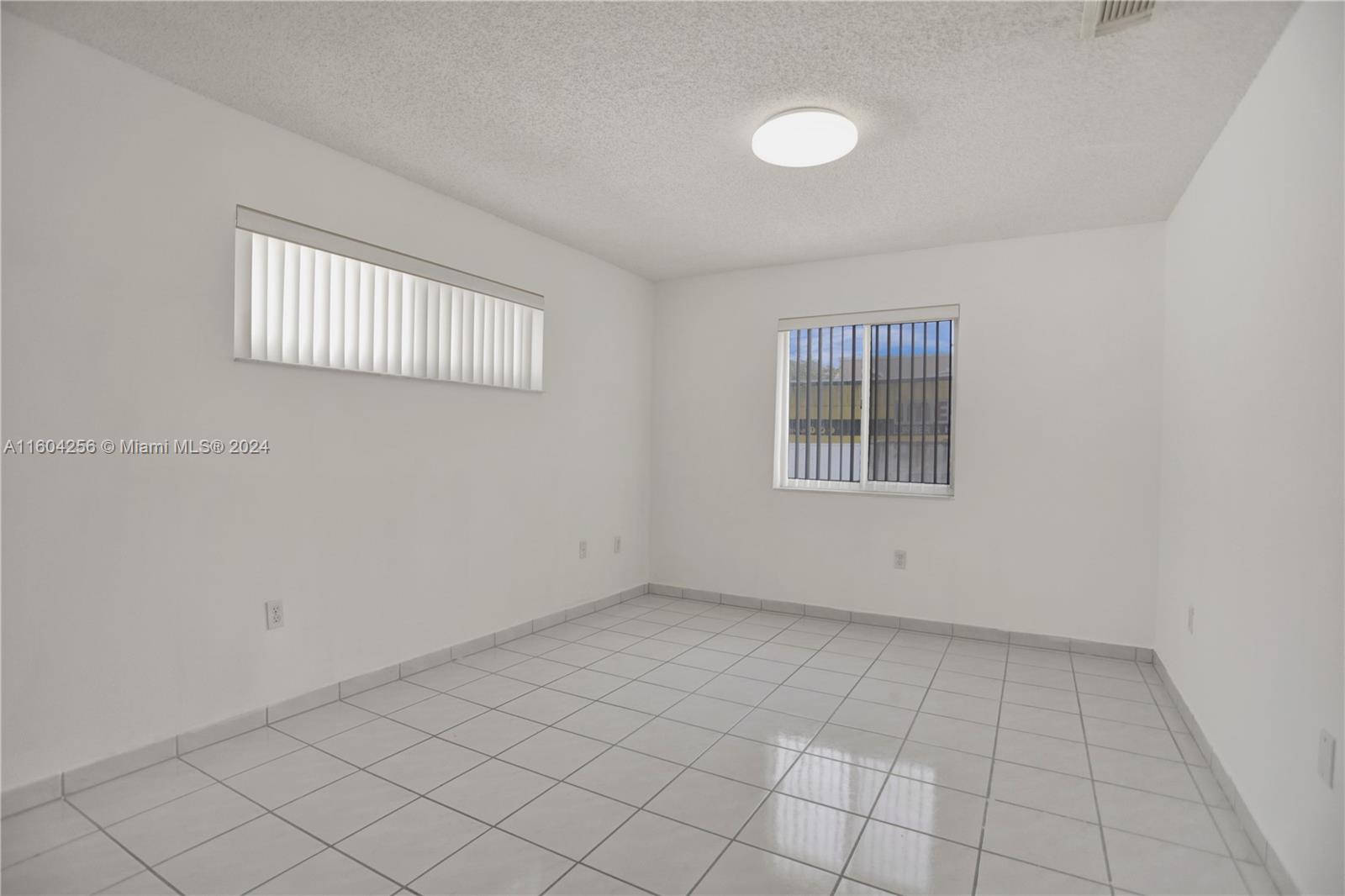 3131 West 79th Place Hialeah, FL 33018 - Photo 15 of 38 an empty room with windows