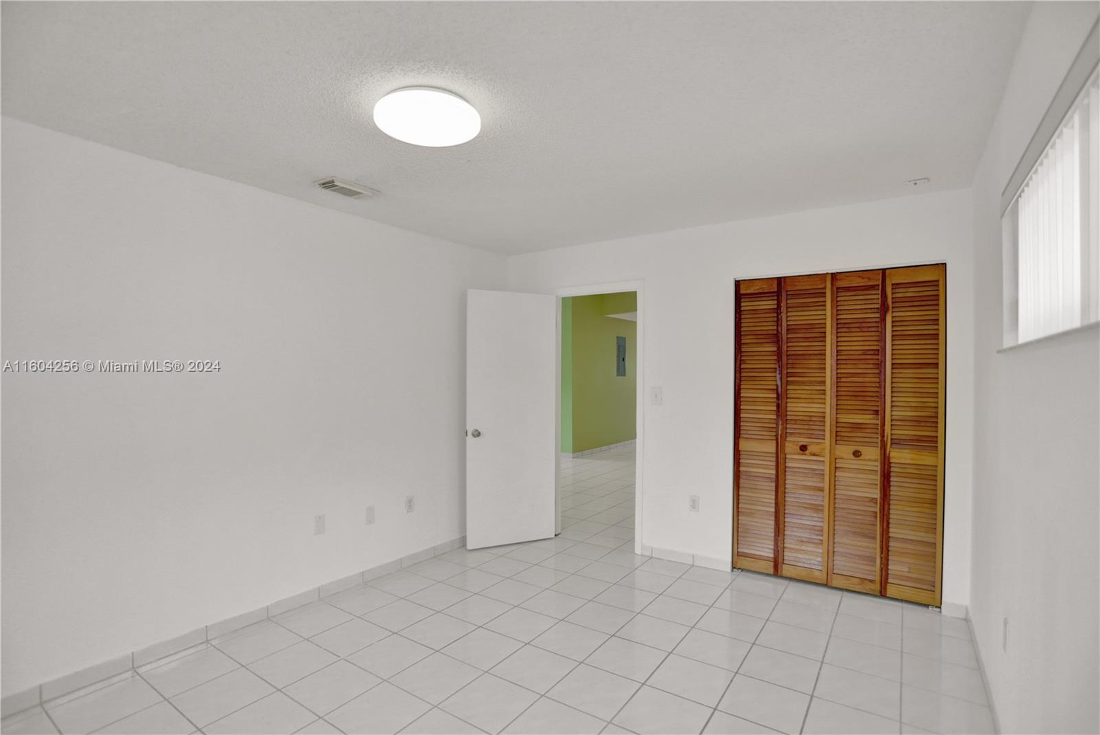 3131 West 79th Place Hialeah, FL 33018 - Photo 17 of 38 a view of an empty room with window and cabinet