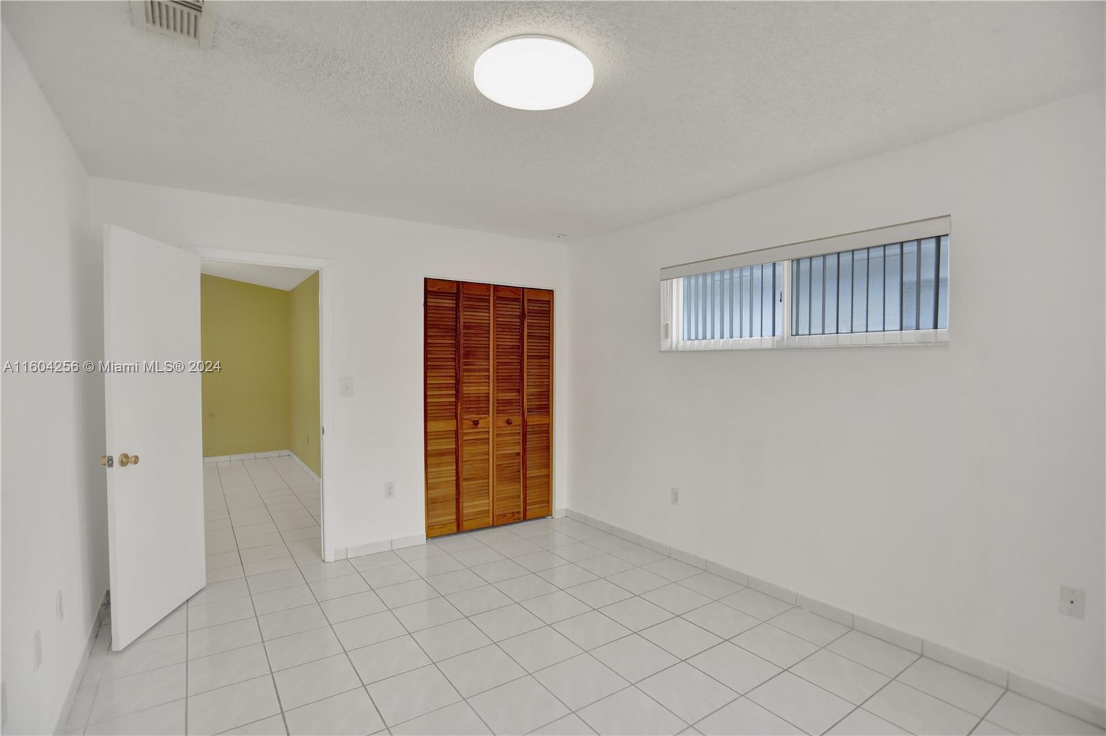 3131 West 79th Place Hialeah, FL 33018 - Photo 18 of 38 an empty room with windows