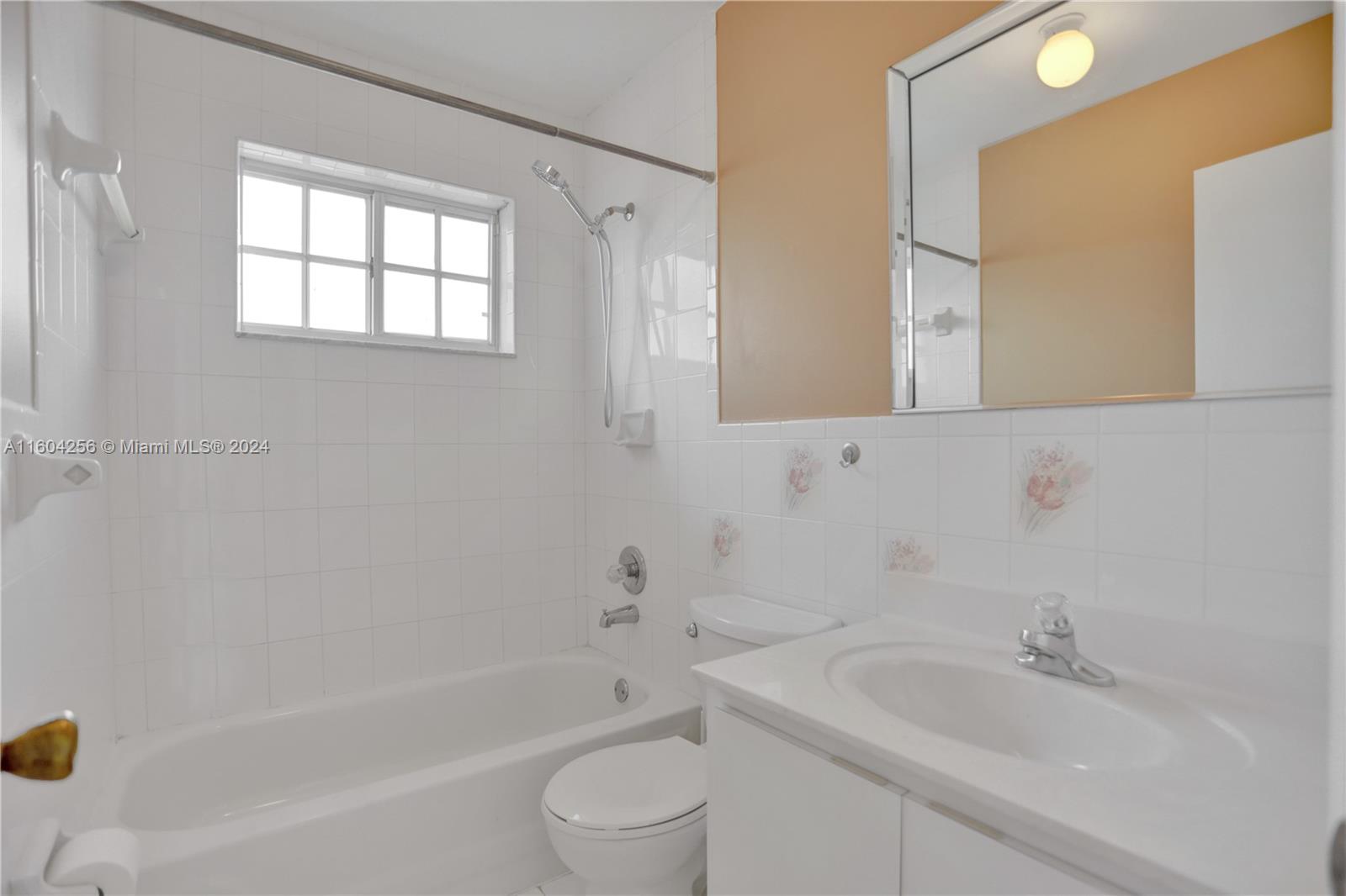 3131 West 79th Place Hialeah, FL 33018 - Photo 24 of 38 a bathroom with a sink mirror toilet and bathtub