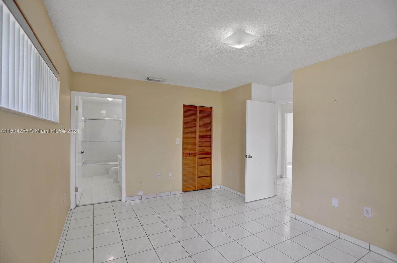3131 West 79th Place Hialeah, FL 33018 - Photo 28 of 38 a view of an empty room with closet and a window