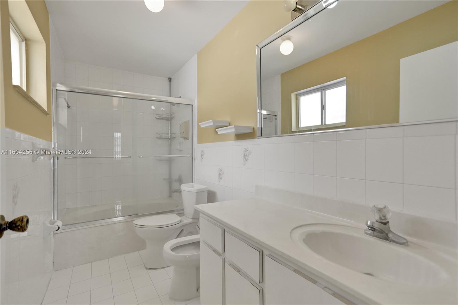 3131 West 79th Place Hialeah, FL 33018 - Photo 30 of 38 a bathroom with a sink a toilet and shower