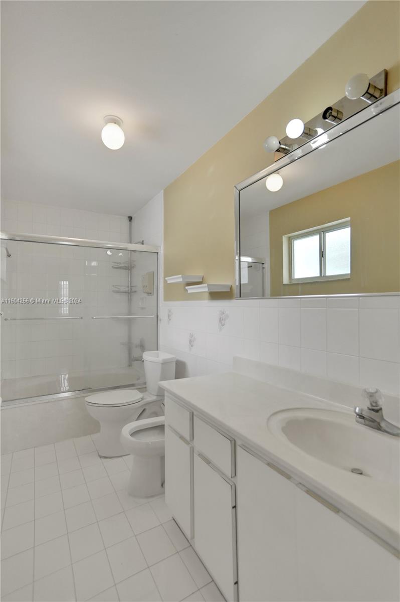 3131 West 79th Place Hialeah, FL 33018 - Photo 31 of 38 a bathroom with a sink a toilet and shower