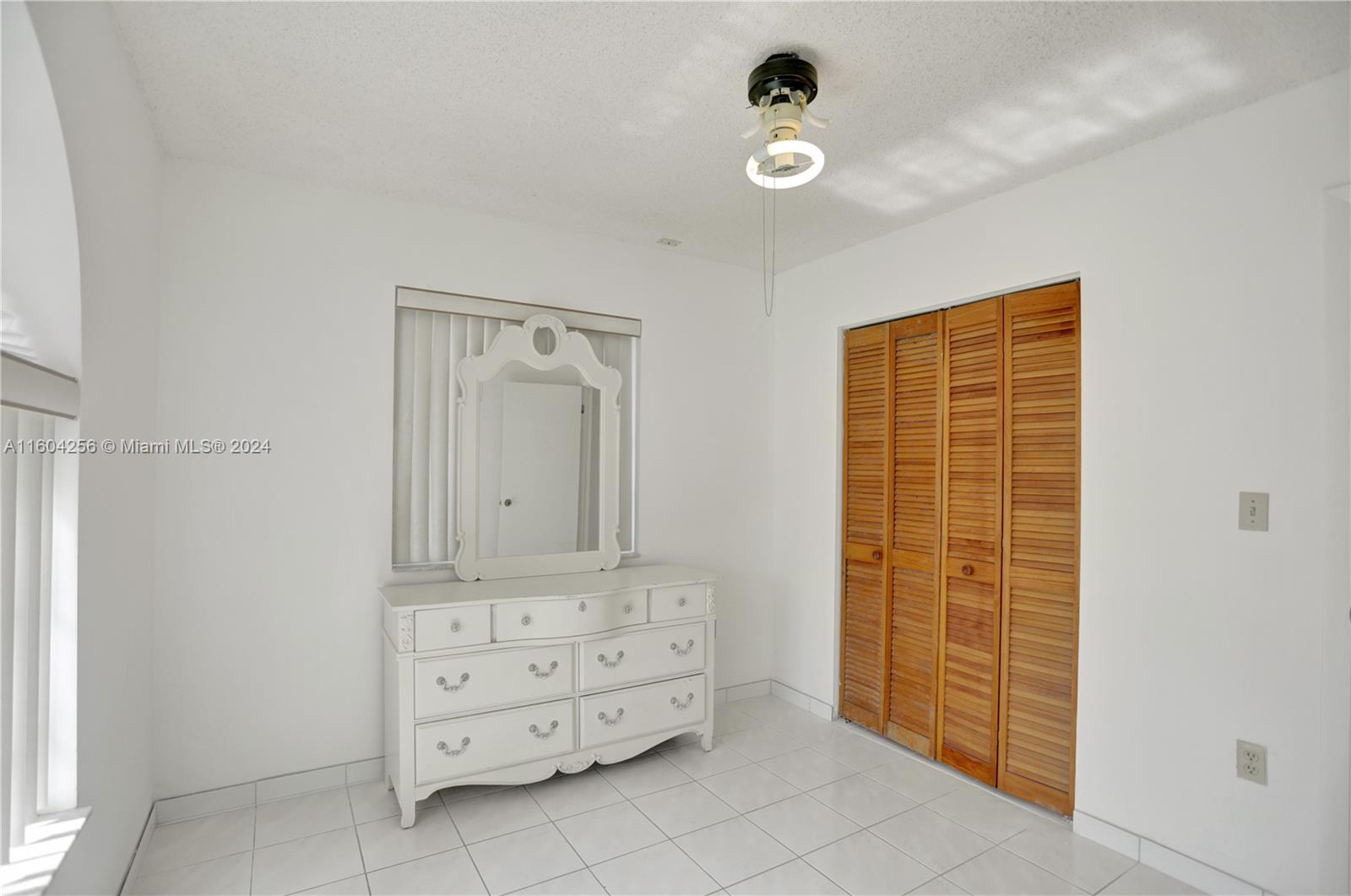 3131 West 79th Place Hialeah, FL 33018 - Photo 34 of 38 a bathroom with a granite countertop sink and a mirror