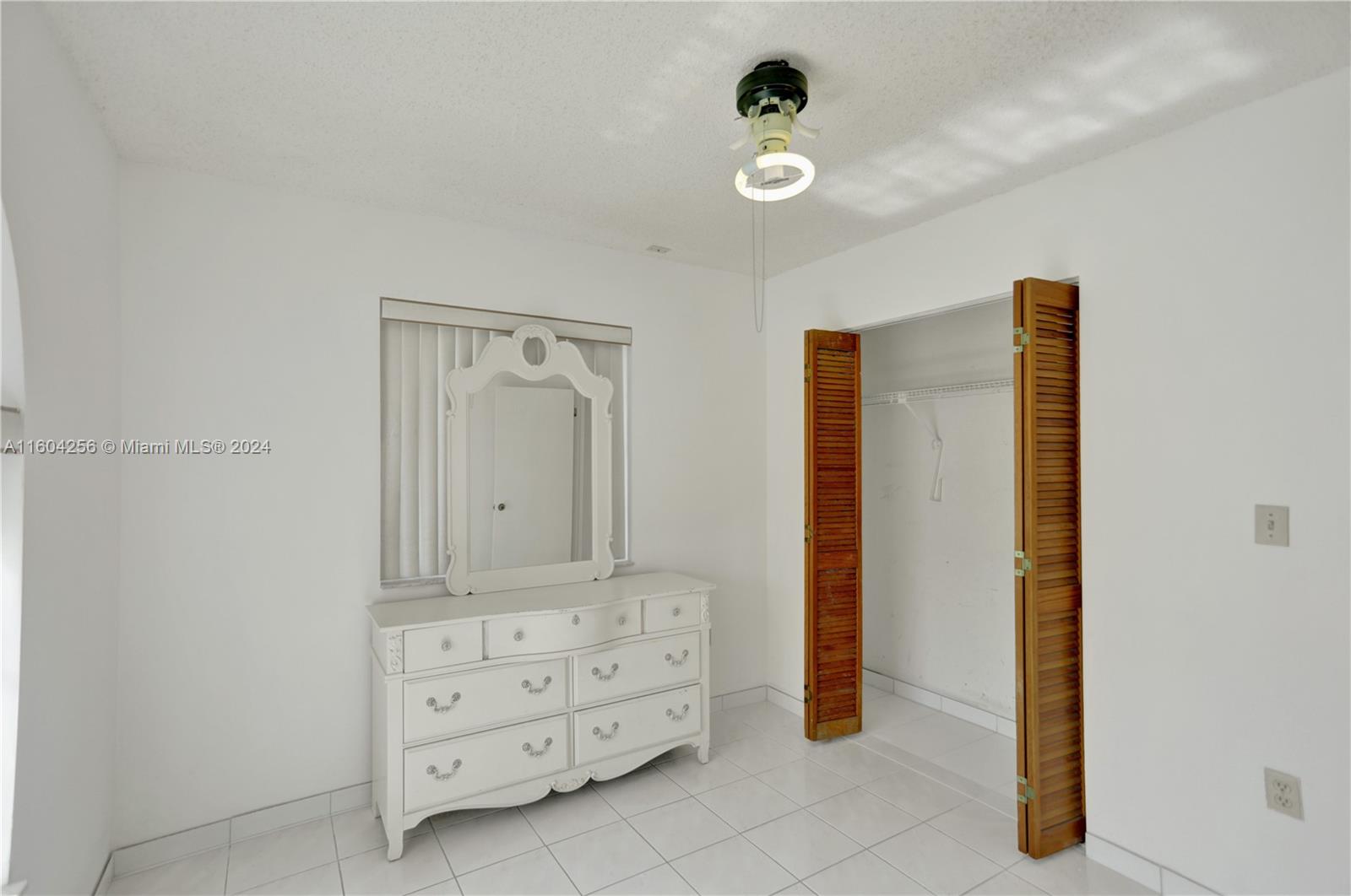 3131 West 79th Place Hialeah, FL 33018 - Photo 38 of 38 a bathroom with a granite countertop sink and a mirror