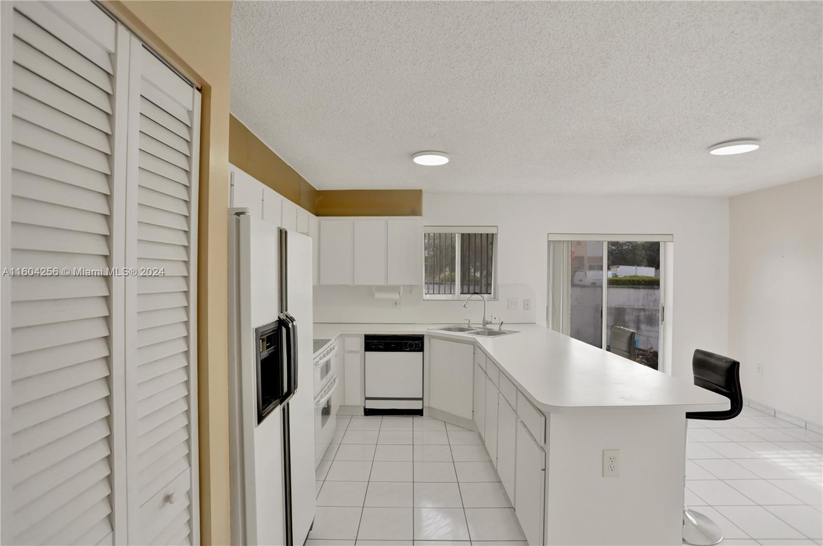 3131 West 79th Place Hialeah, FL 33018 - Photo 10 of 38 a kitchen with a sink and refrigerator
