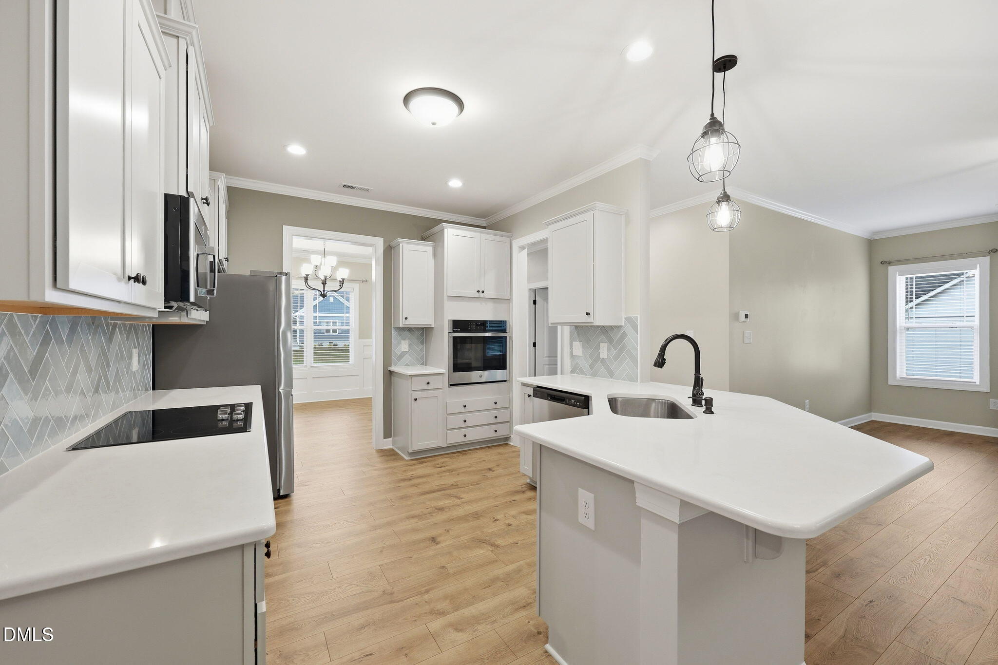 146 Seahawk Way Zebulon, NC 27597 - Photo 16 of 51 a large white kitchen with a stove a sink a refrigerator and island