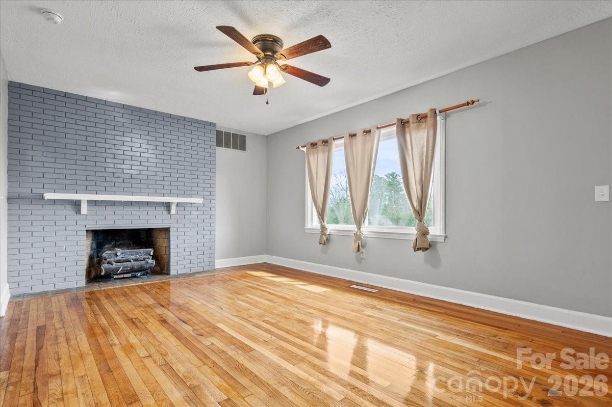 2541 Highway 145 Chesterfield, SC 29709 - Photo 11 of 47 a view of empty room with wooden floor and fireplace