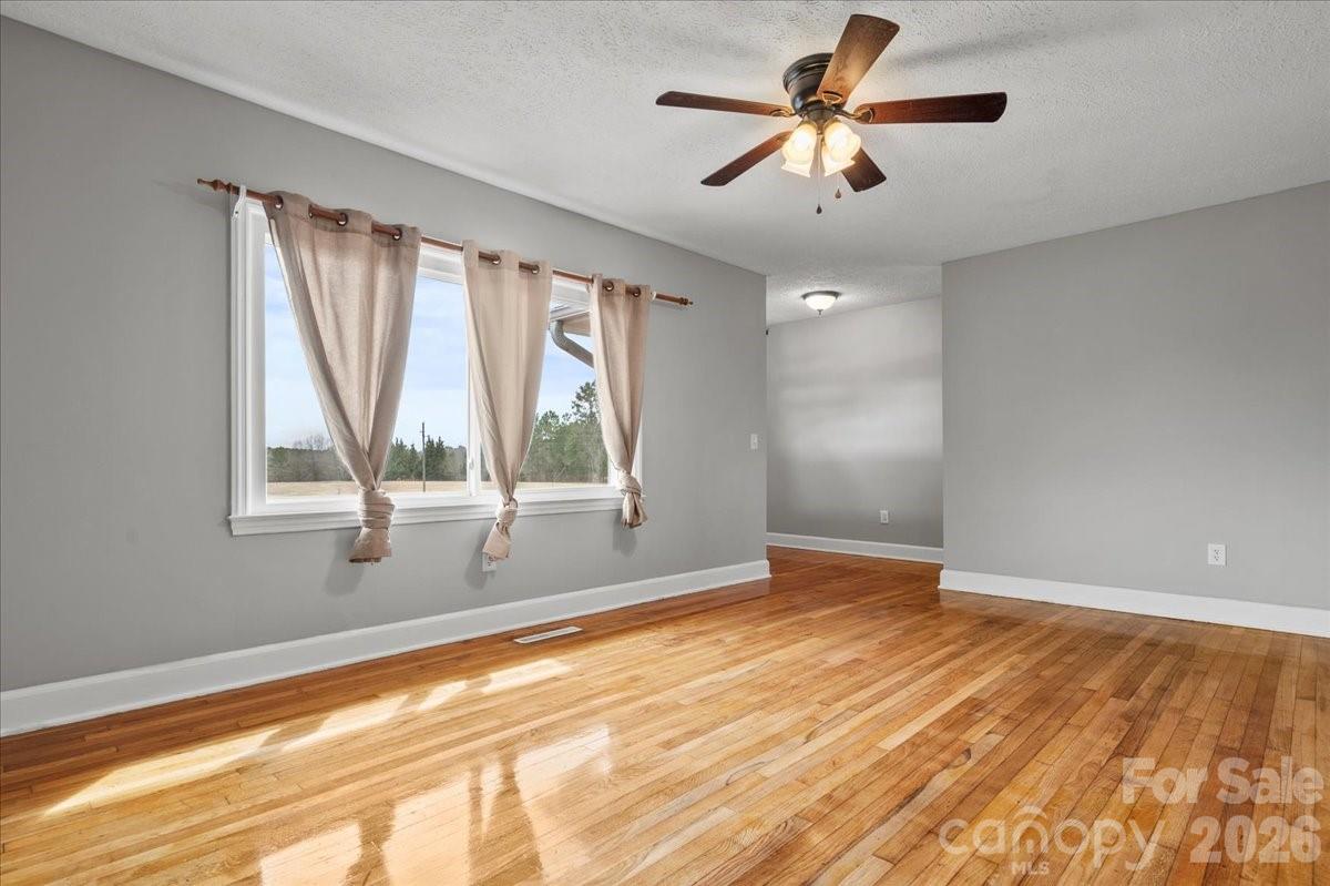 2541 Highway 145 Chesterfield, SC 29709 - Photo 12 of 47 a view of empty room with wooden floor and fan