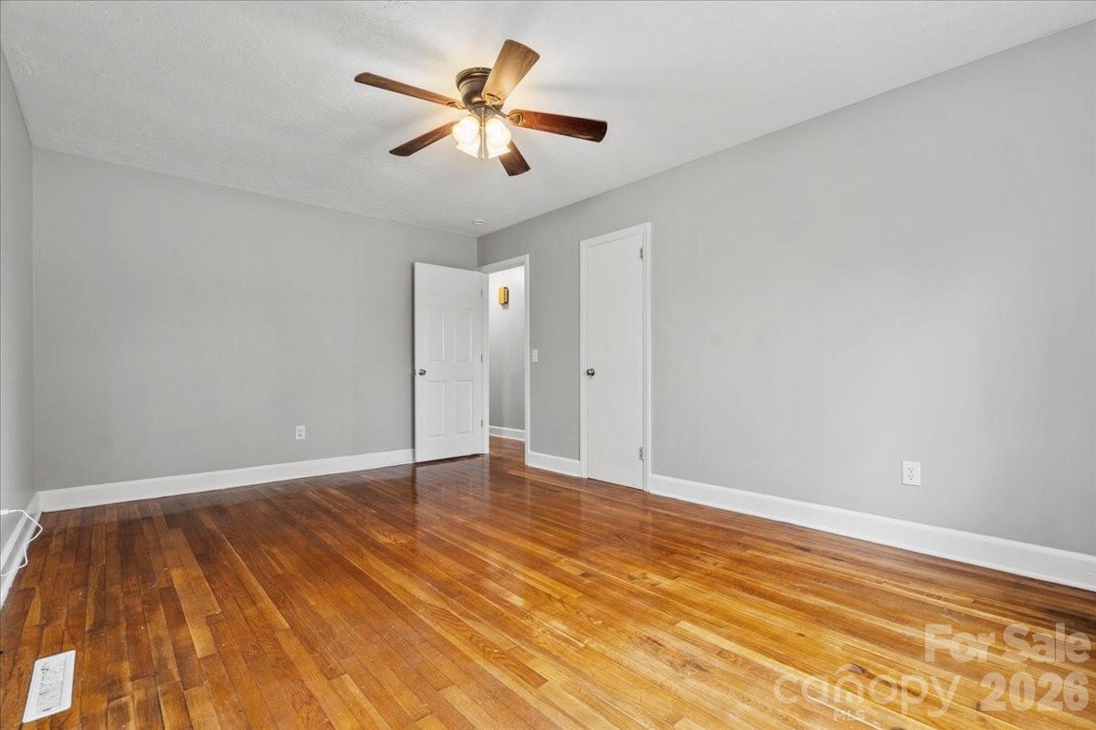2541 Highway 145 Chesterfield, SC 29709 - Photo 22 of 47 an empty room with wooden floor and windows
