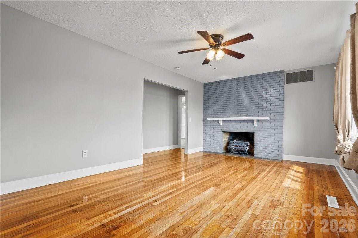 2541 Highway 145 Chesterfield, SC 29709 - Photo 10 of 47 a view of empty room with wooden floor and fireplace