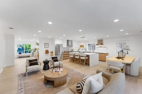 a living room with furniture a pool table and chairs