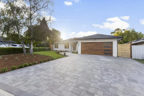 a view of a house with a yard and garage
