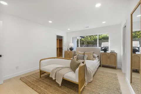 a bed room with a bed and a large window