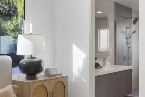 a bathroom with a sink mirror and vanity