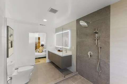 a spacious bathroom with a sink toilet and shower