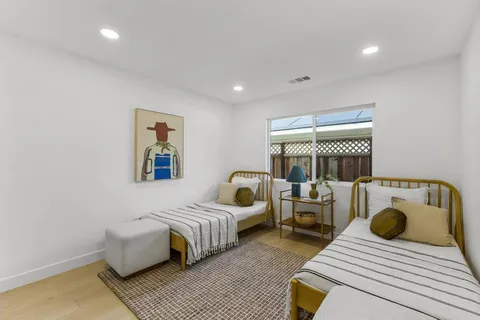 a bedroom with furniture and a wooden floor