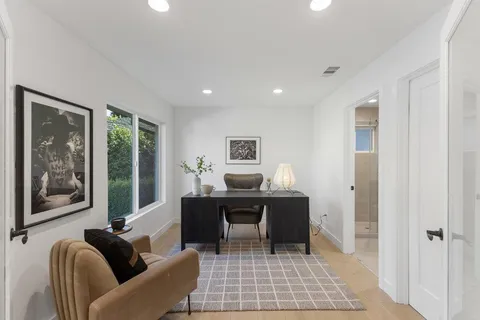 a living room with furniture and large window