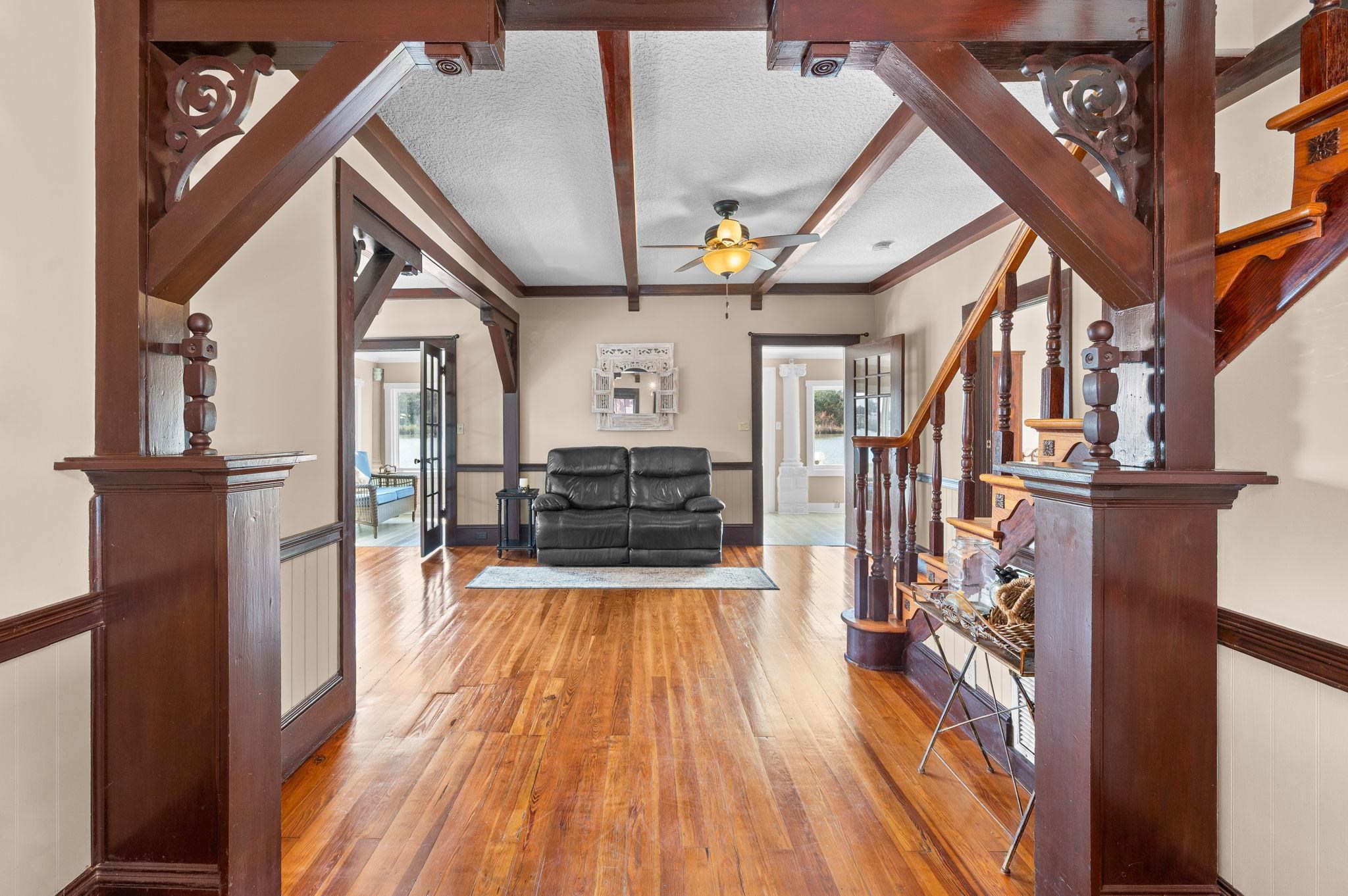 59 Lewis Boulevard St. Augustine, FL 32084 - Photo 14 of 75 Living area with a wainscoted wall, a textured ceiling, hardwood / wood-style flooring, and a ceiling fan