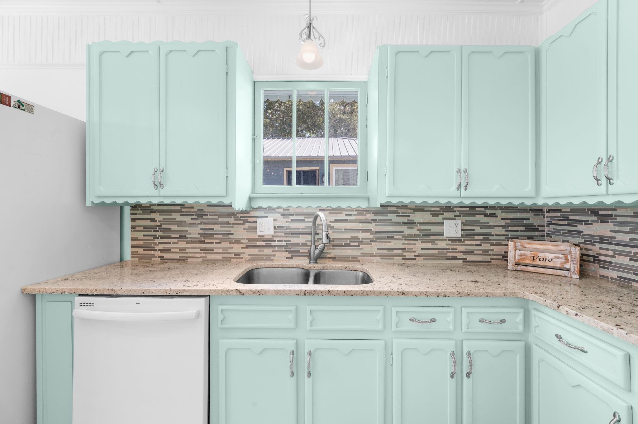 59 Lewis Boulevard St. Augustine, FL 32084 - Photo 17 of 75 Kitchen featuring dishwasher, pendant lighting, and light stone counters