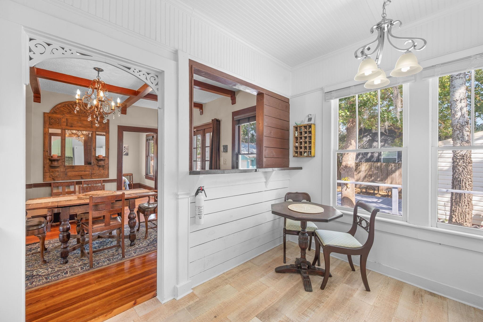 59 Lewis Boulevard St. Augustine, FL 32084 - Photo 18 of 75 Dining room featuring a chandelier, wood finished floors, wood walls, and beamed ceiling