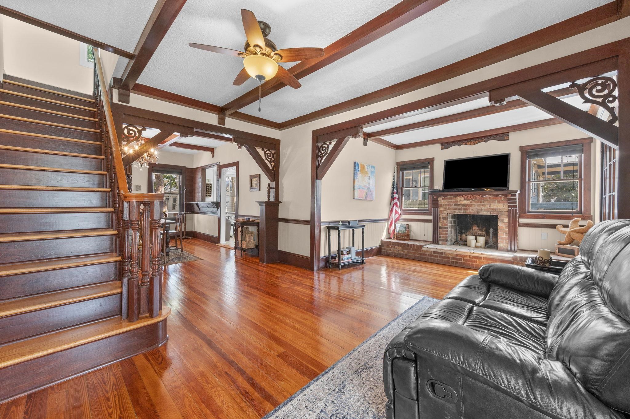59 Lewis Boulevard St. Augustine, FL 32084 - Photo 2 of 75 Living room with hardwood / wood-style floors, a brick fireplace, crown molding, and a ceiling fan