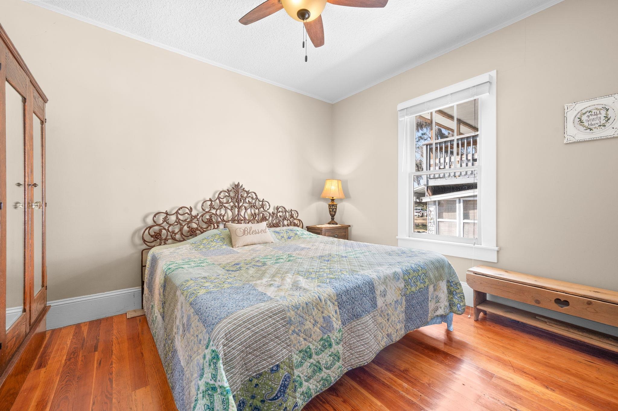 59 Lewis Boulevard St. Augustine, FL 32084 - Photo 21 of 75 Bedroom featuring wood finished floors, ceiling fan, crown molding, and a textured ceiling