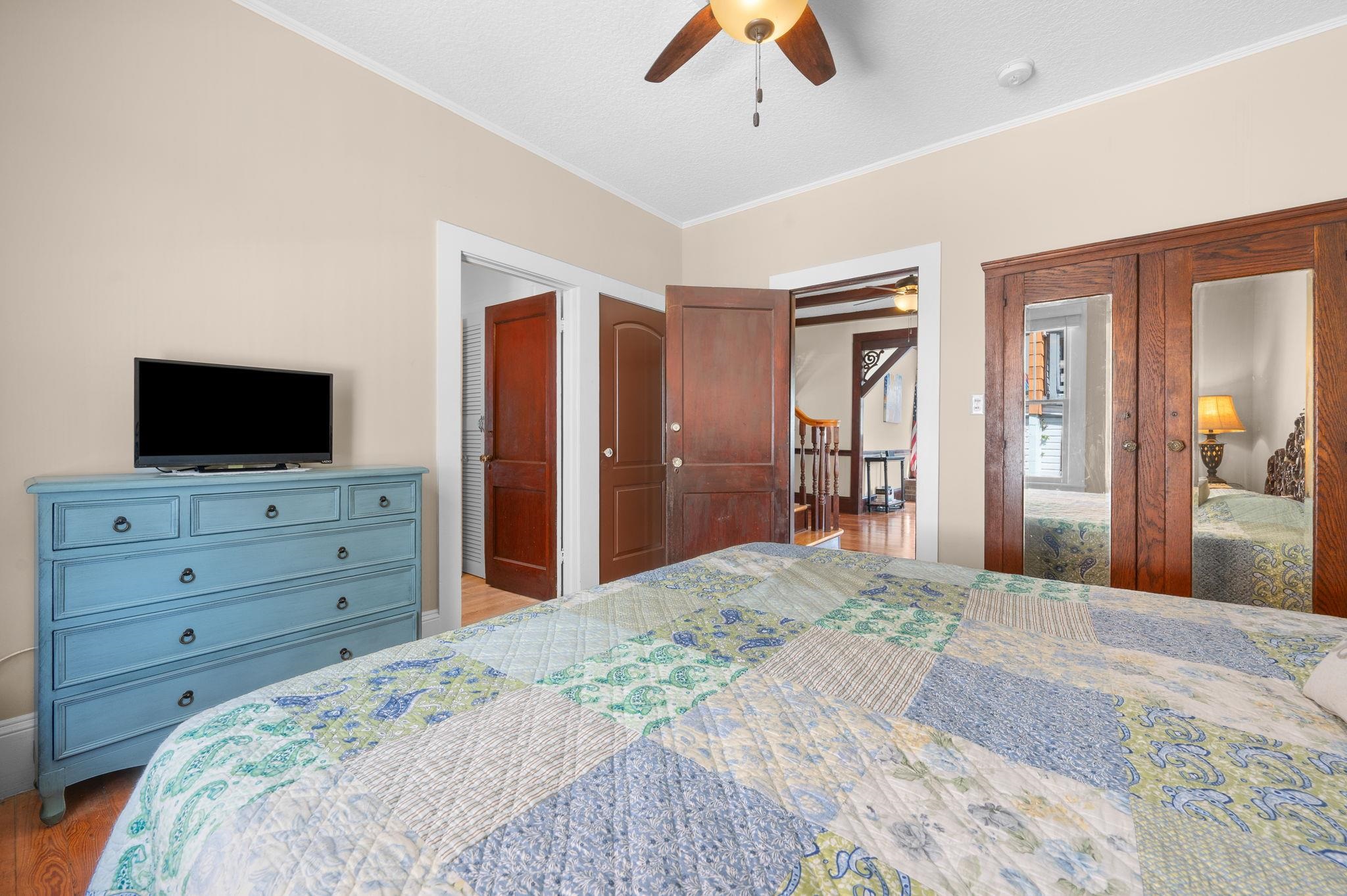 59 Lewis Boulevard St. Augustine, FL 32084 - Photo 22 of 75 Bedroom featuring a closet, ornamental molding, wood finished floors, and a ceiling fan